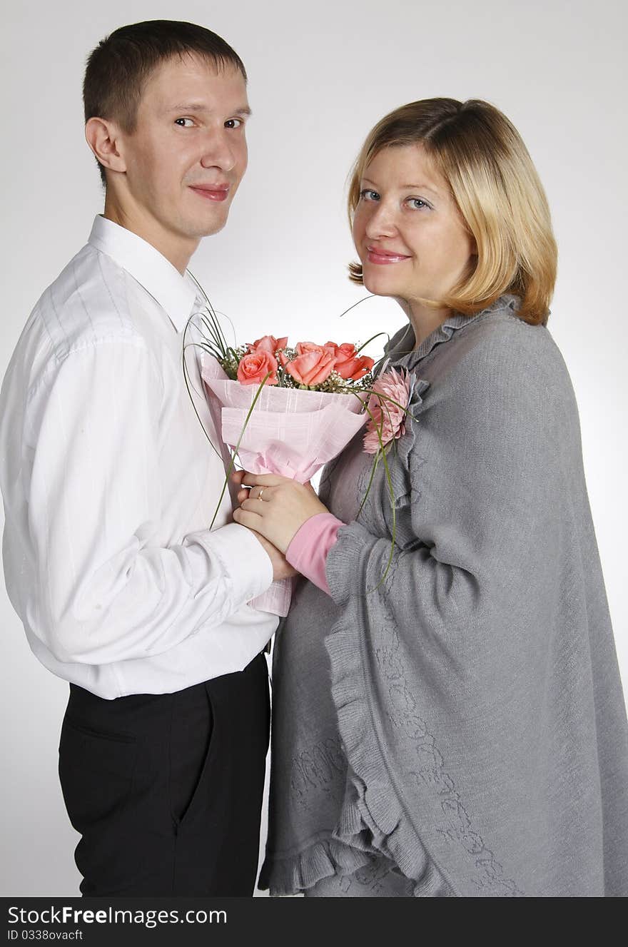 The man and the woman hold a bouquet