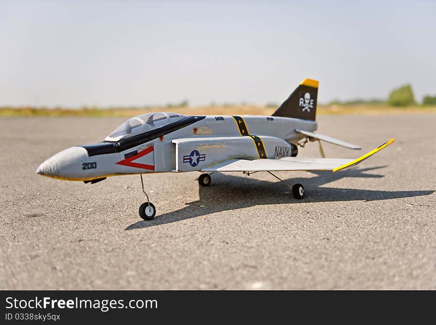 Homemade radio control toy aircraft with electric motor on runway.