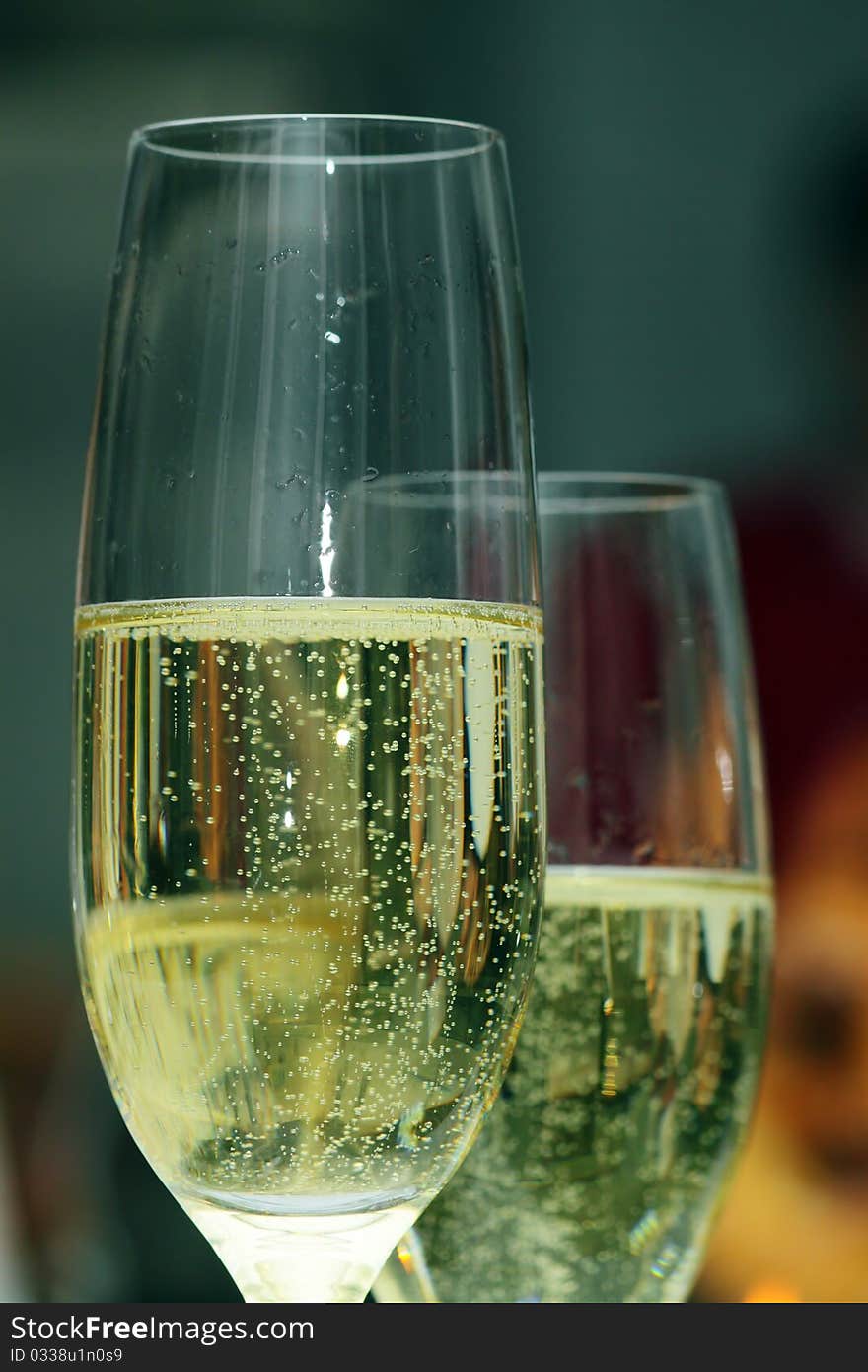 Bubbles in a glass of champagne at the holiday table. Bubbles in a glass of champagne at the holiday table