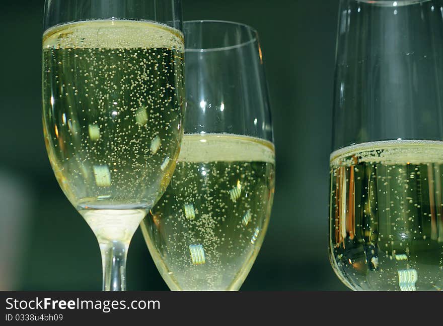 Bubbles in a glass of champagne at the holiday table. Bubbles in a glass of champagne at the holiday table