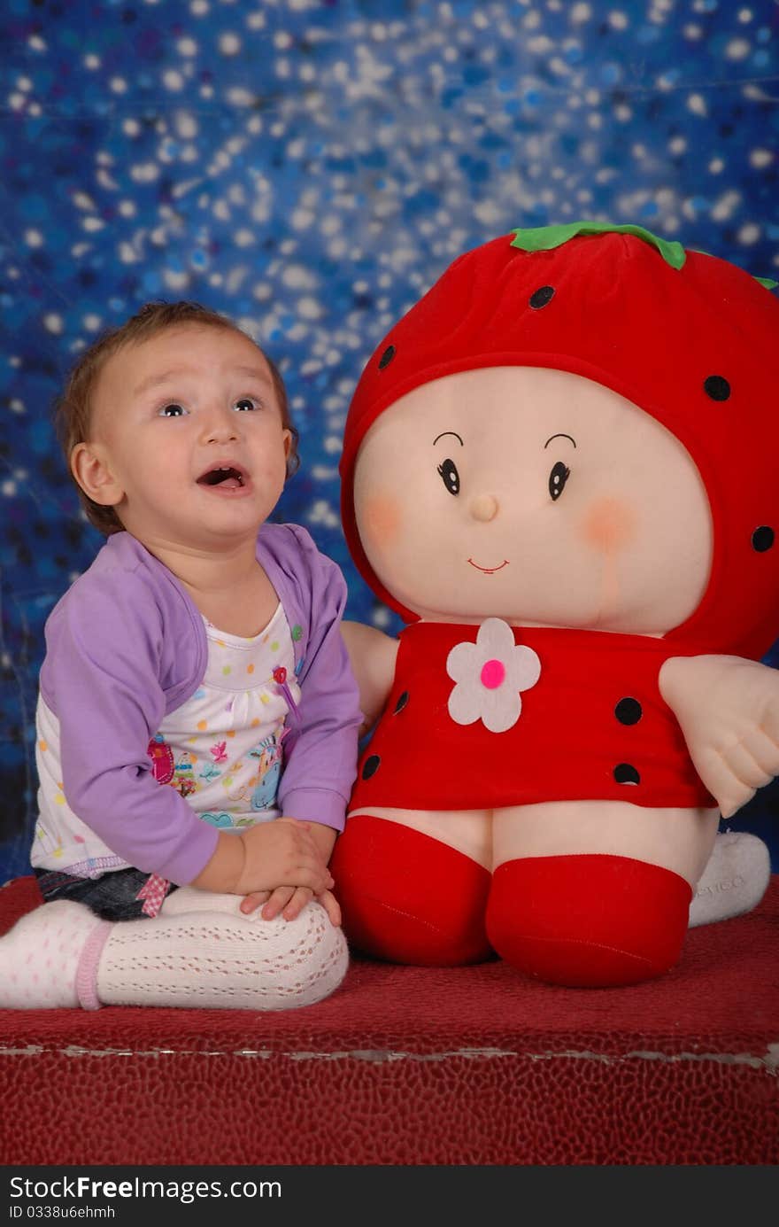 Little girl is playing with toy and smiling. Little girl is playing with toy and smiling