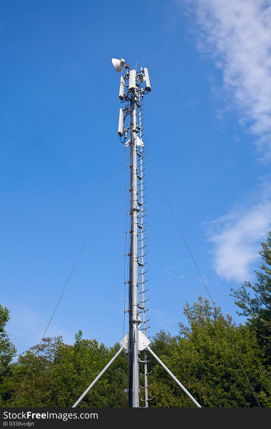 Tall antenna in the middle of the forest