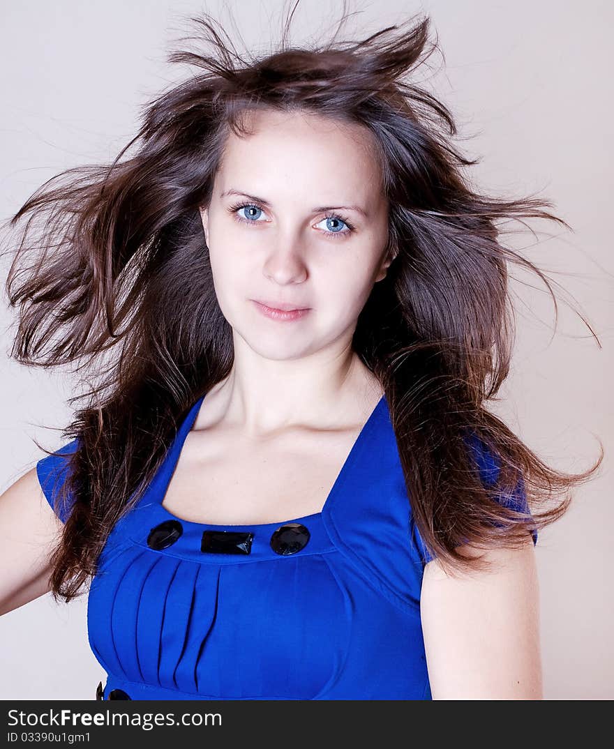 Beauty young woman in blue dress with blue eyes