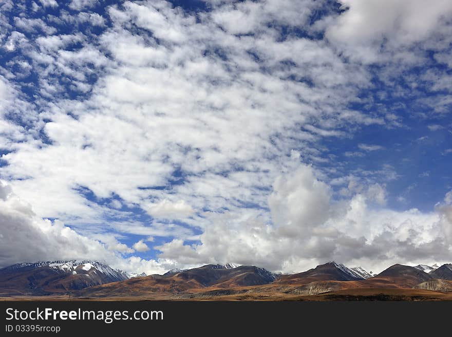 Plateau snowy mountains and clouds in the beautiful scenery