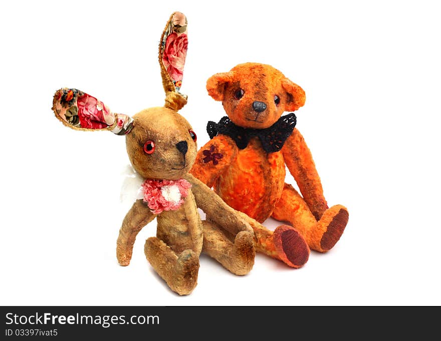 Vintage retro toys isolated on white. Teddy bear and rabbit.