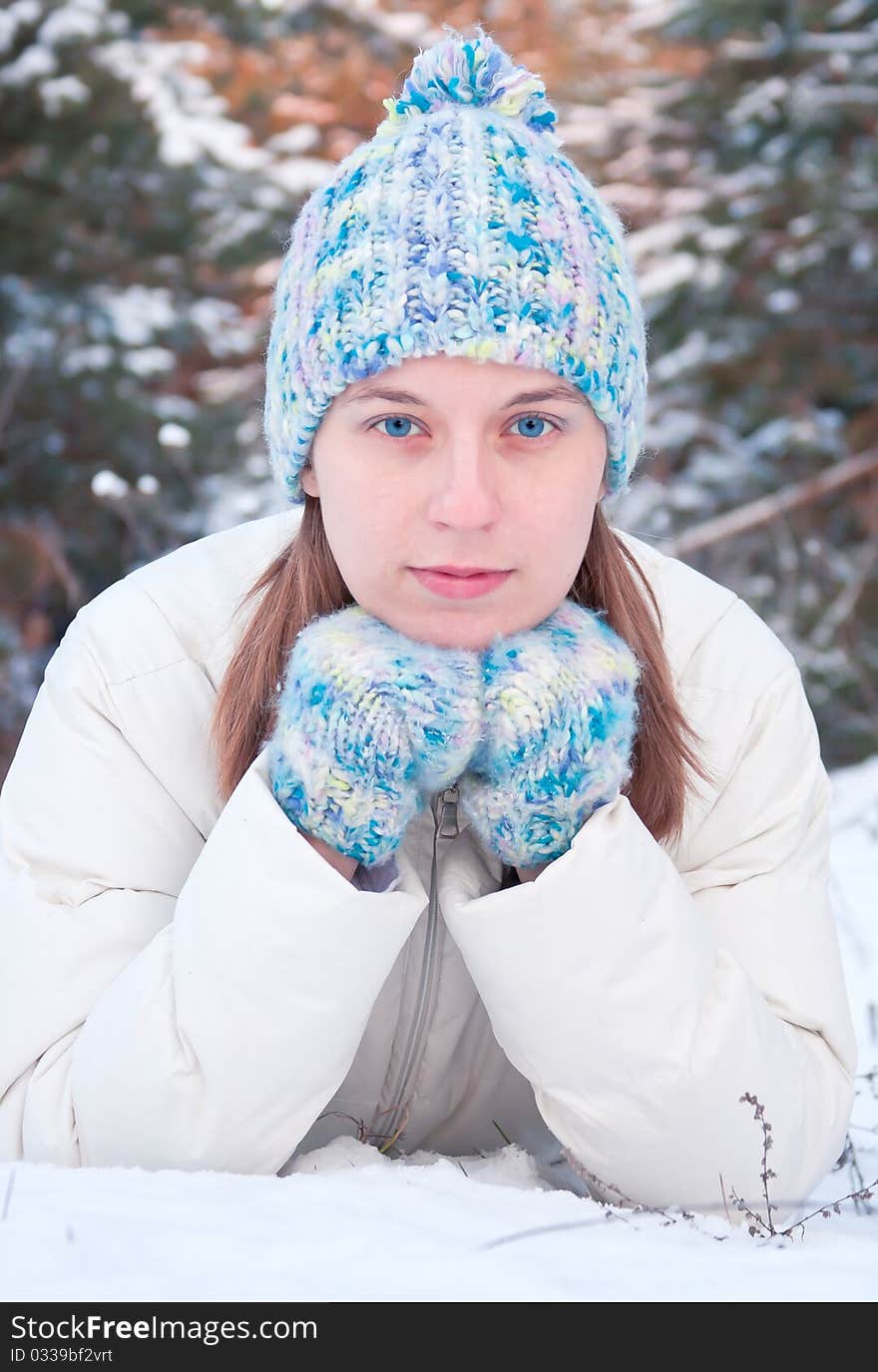 Winter girl behind snow tree