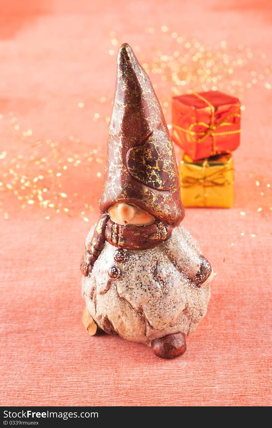 Christmas gnome with gifts on red bacground