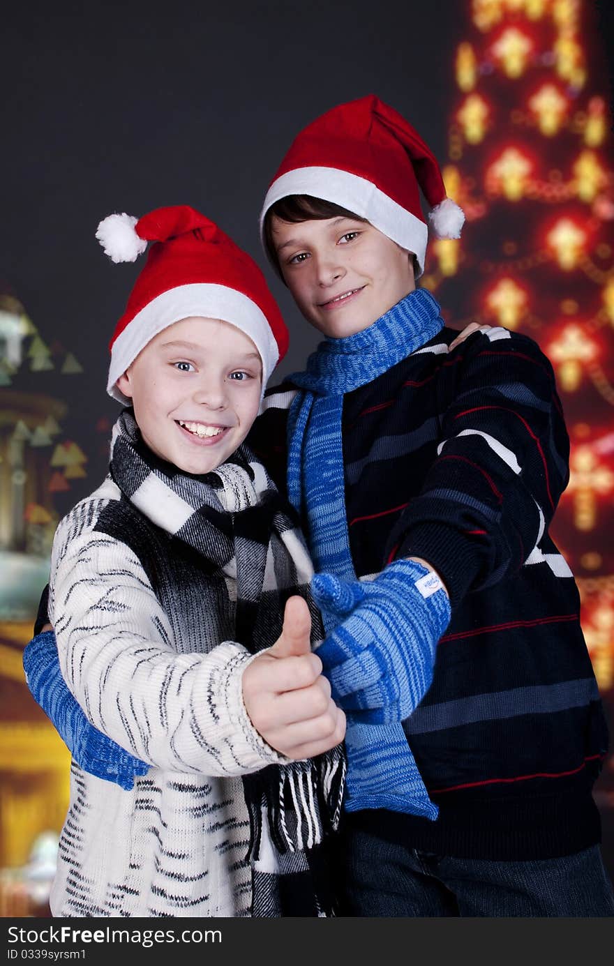 Two happy young boys on Christmas lights the background