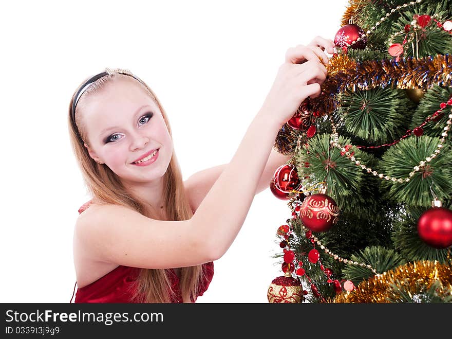 Beautiful girl decorating a Christmas tree. Beautiful girl decorating a Christmas tree