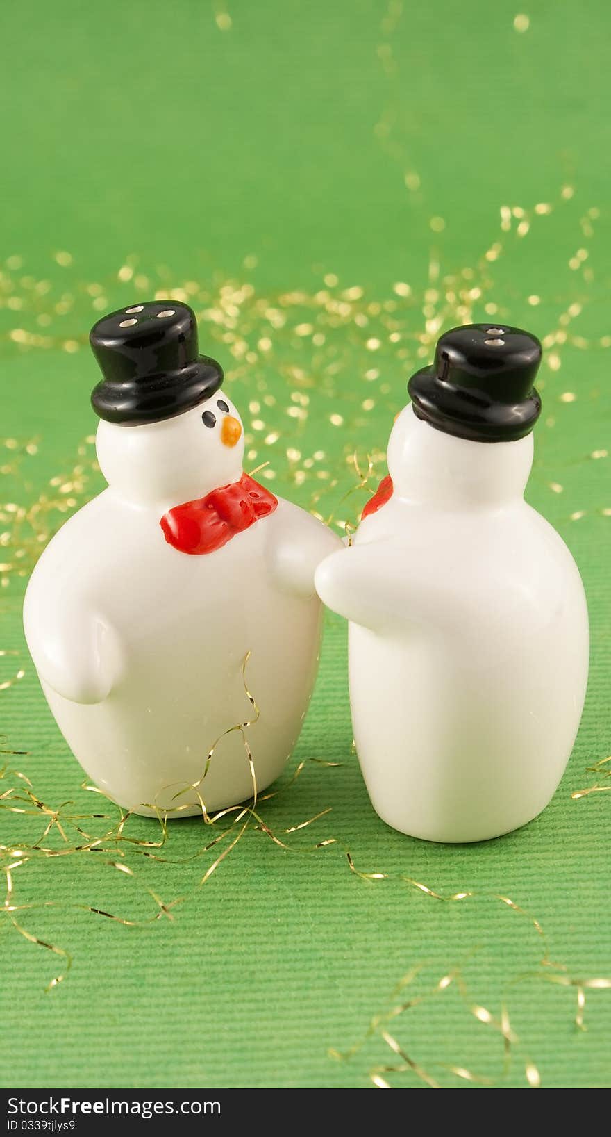 Christmas snowmans with hat on green background