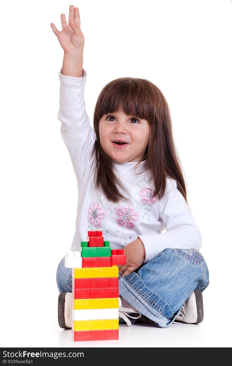 Cute little girl is constructing using building blocks