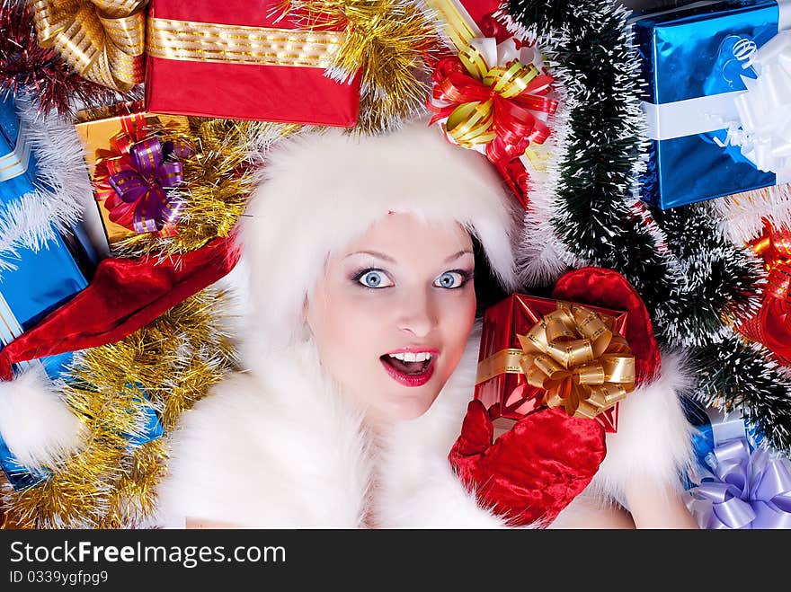 Christmas girl in santa hat with stack gift box. Christmas girl in santa hat with stack gift box