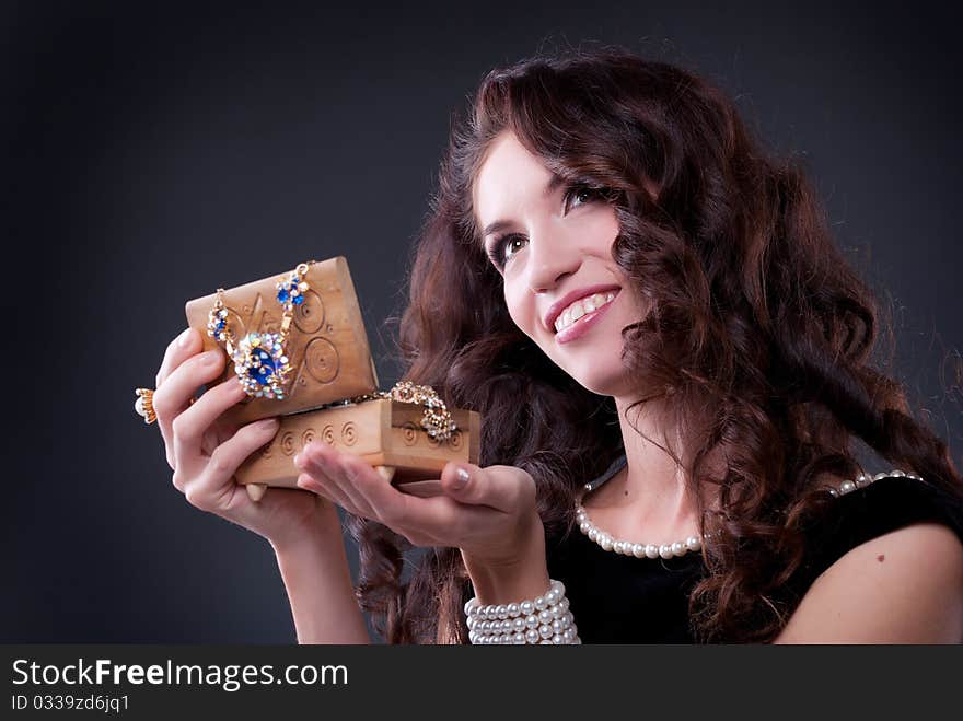 Beautiful young brunette woman with a casket