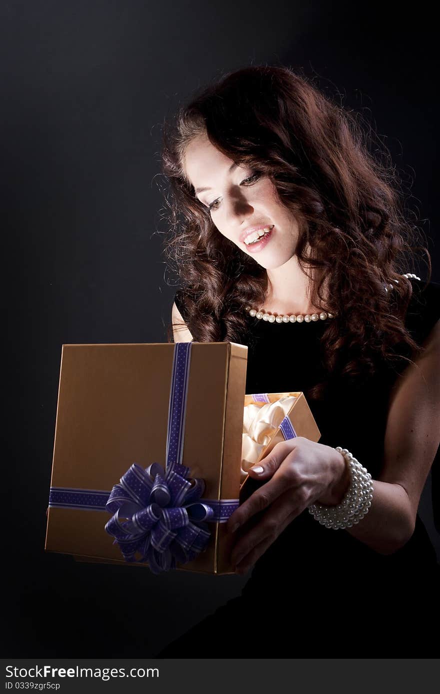 Beautiful young brunette woman with a present. Beautiful young brunette woman with a present