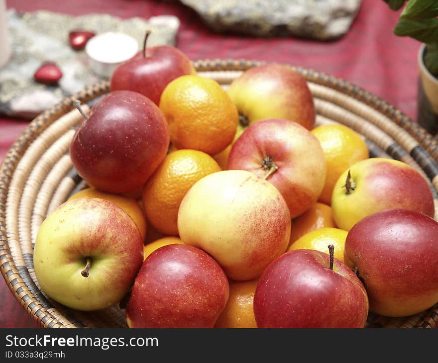 Red apples and mandarin oranges in a basket