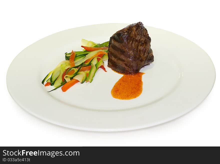 Gourmet fillet steak with vegetables on the white plate. Isolated on white background with clipping path.