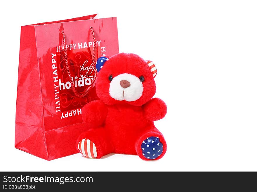 Red teddy bear as christmas gift isolated on white