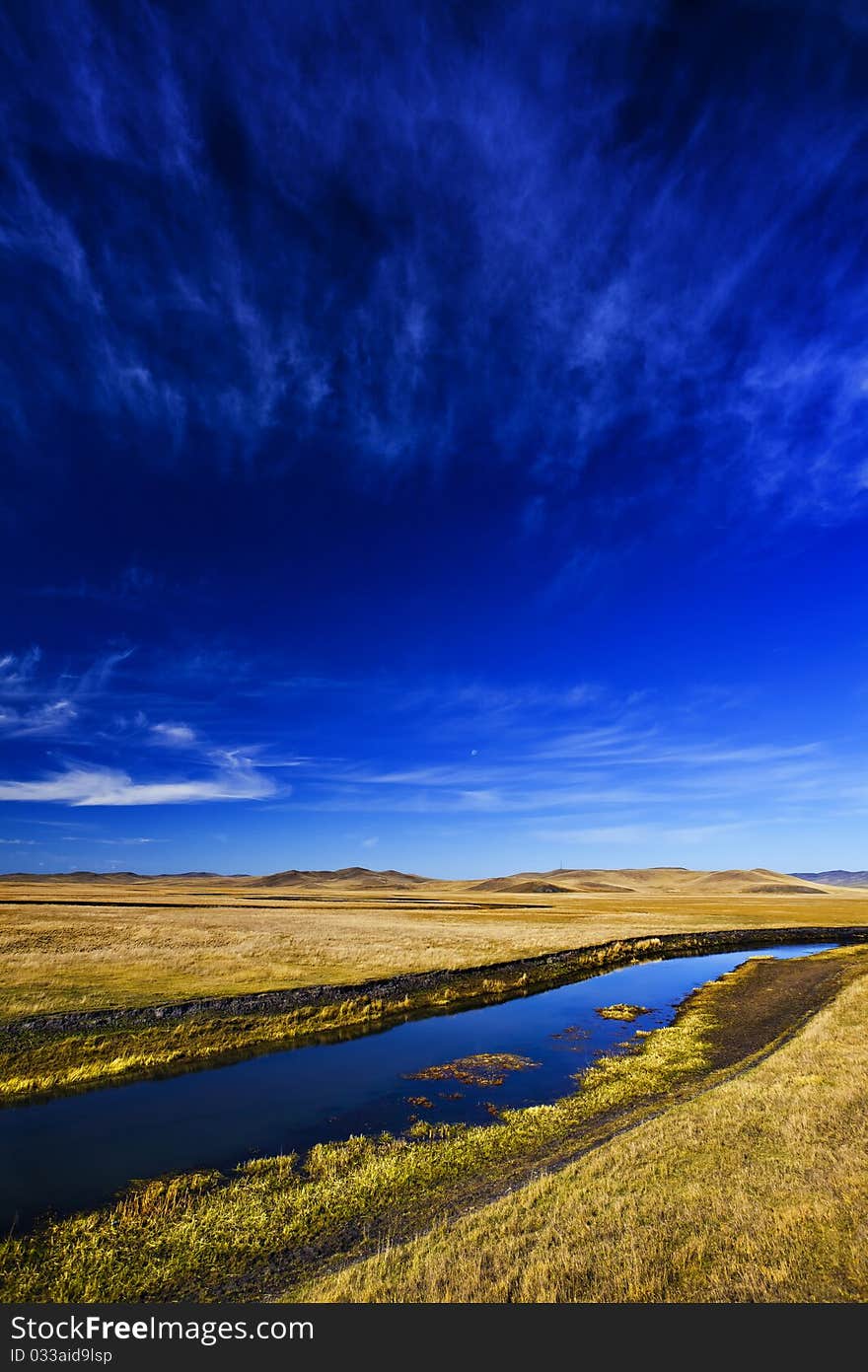 Stream between pastures and sky. Stream between pastures and sky.