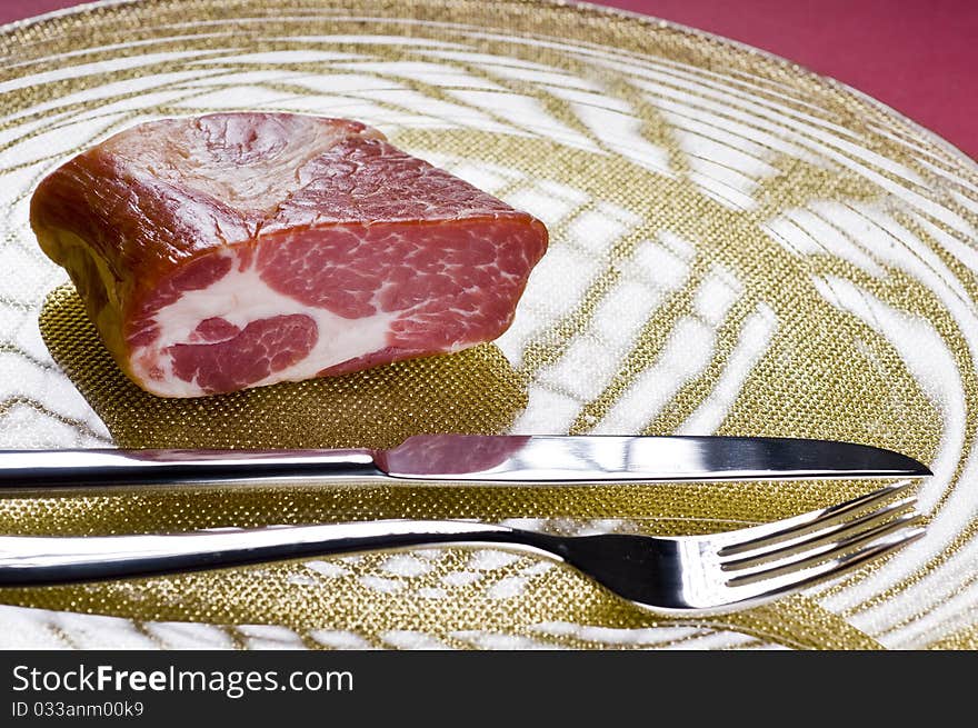 Raw meat on a plate over color background