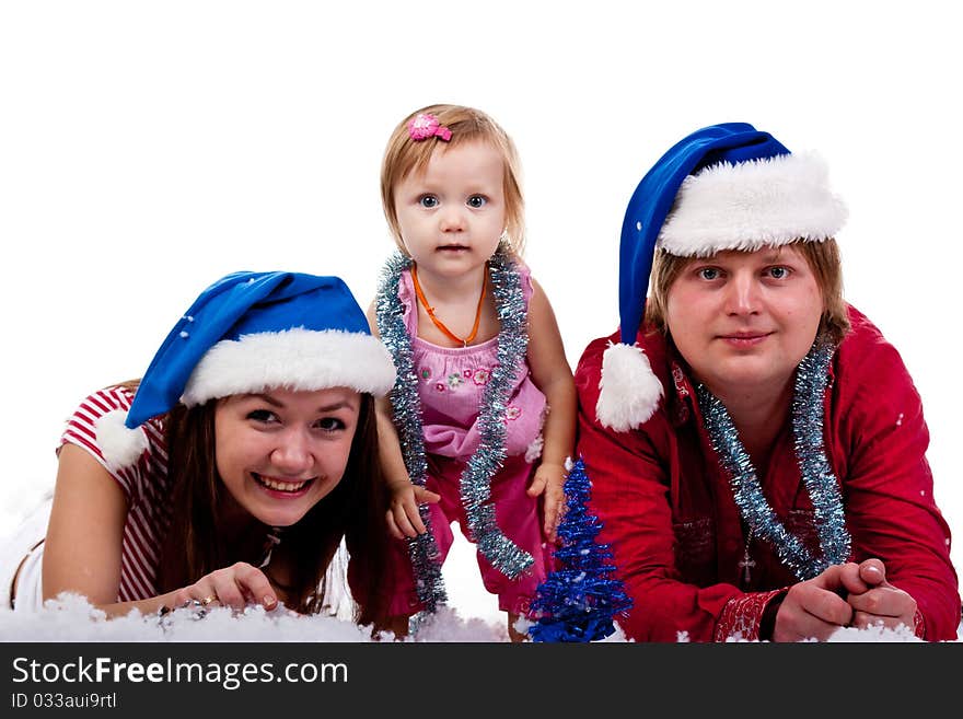 Family in Santa s hat lying in artificial snow