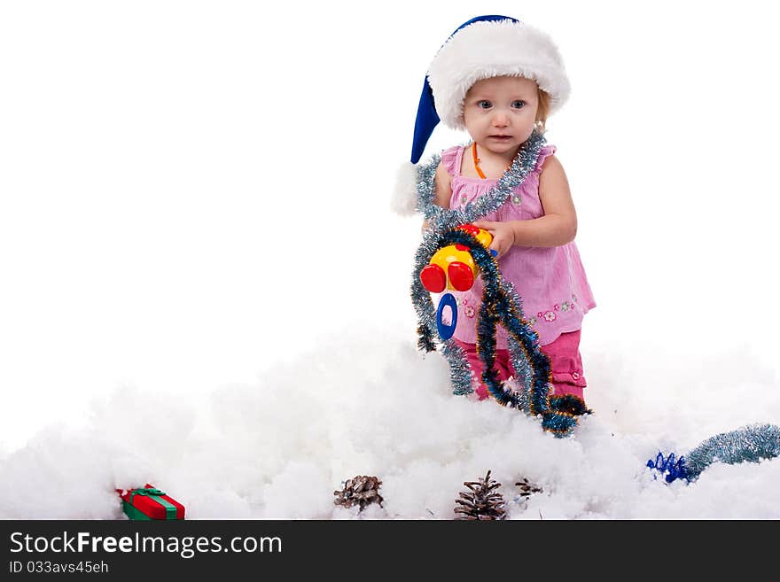 Baby In Santa S Hat In Tinsel And Artificial Snow