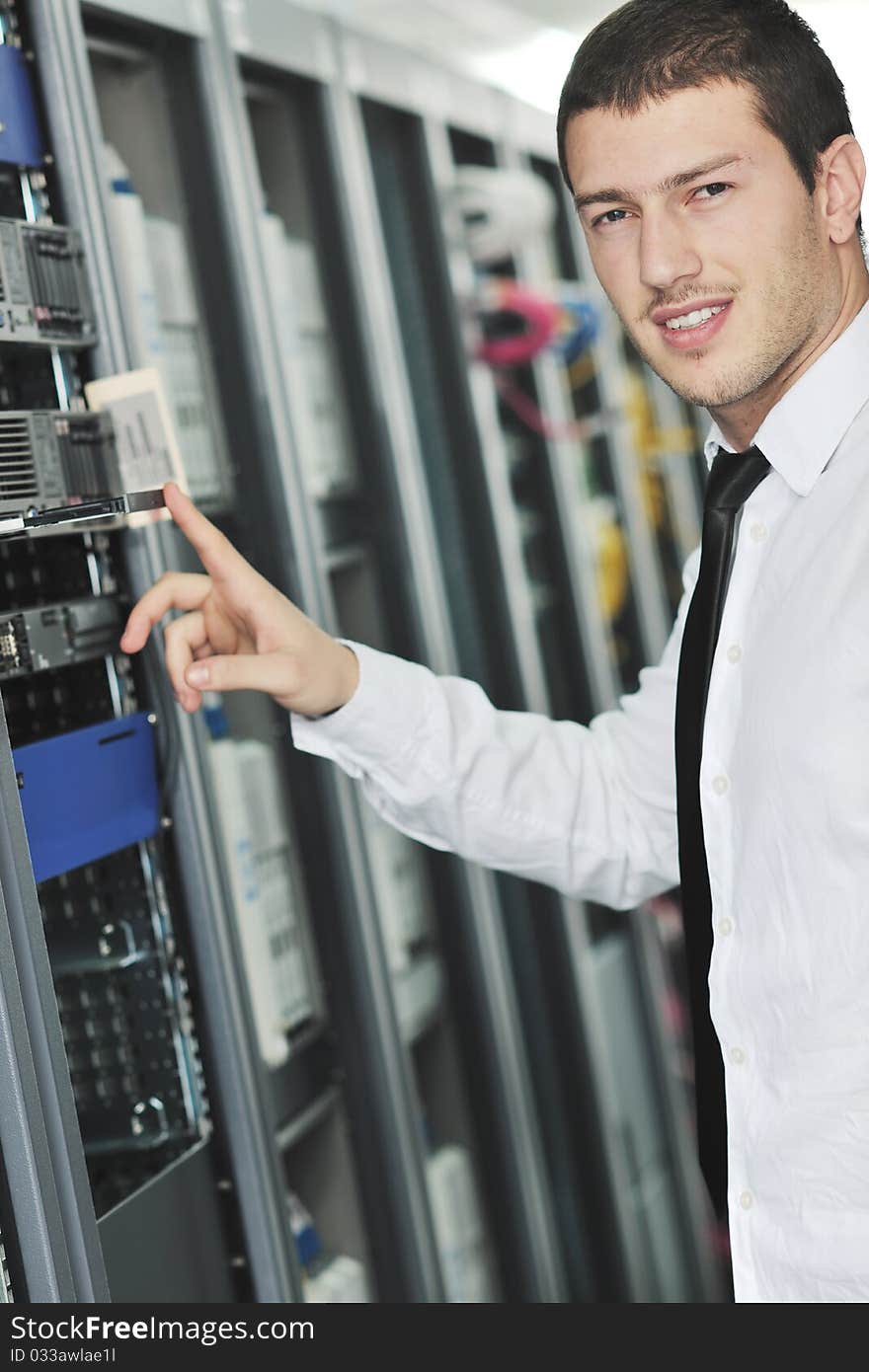 Young engeneer in datacenter server room