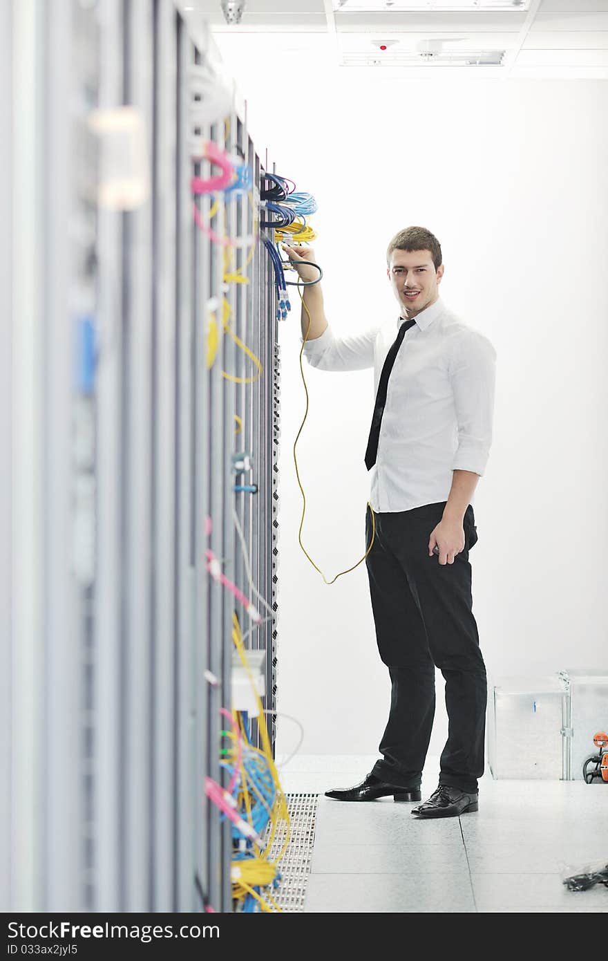 Young Engeneer In Datacenter Server Room