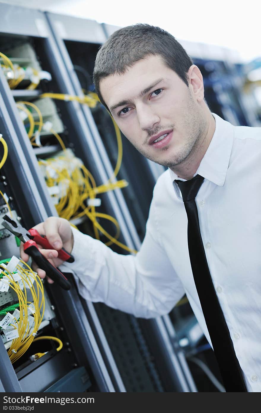 Young engeneer in datacenter server room