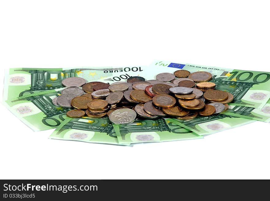 Banknotes and coins on the table on a white background. Banknotes and coins on the table on a white background