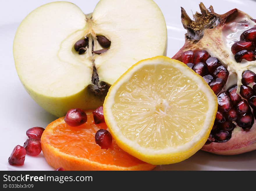 Lemon, orange, apple and pomegranate isolated on white background. Lemon, orange, apple and pomegranate isolated on white background