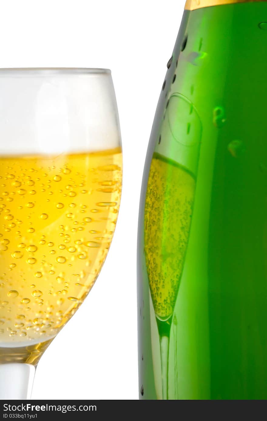 A glass and a bottle of champagne isolated on a white background