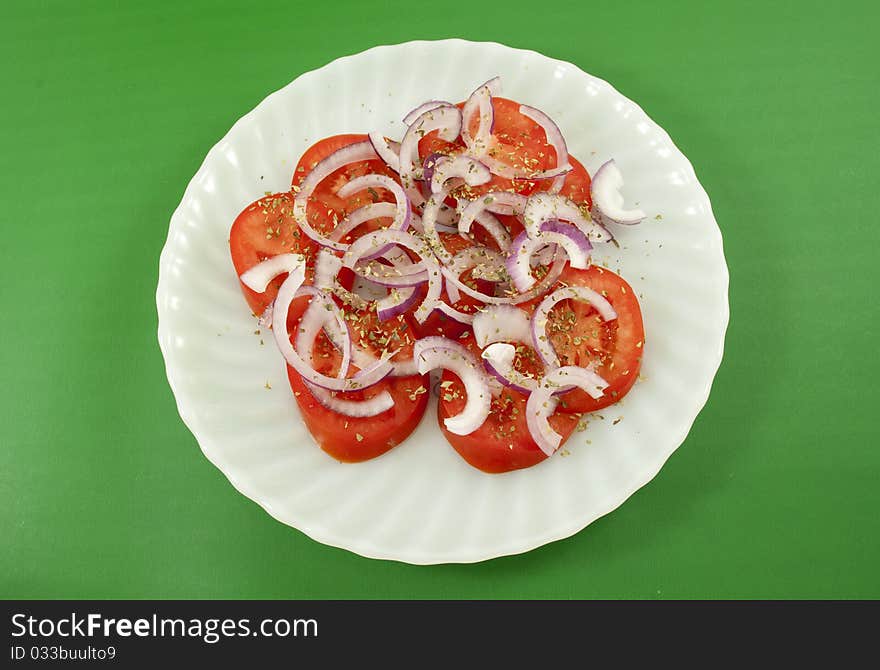 Tomato and onion salad isolated on white background