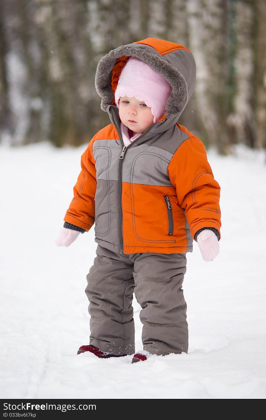 Cute baby stay on snow road