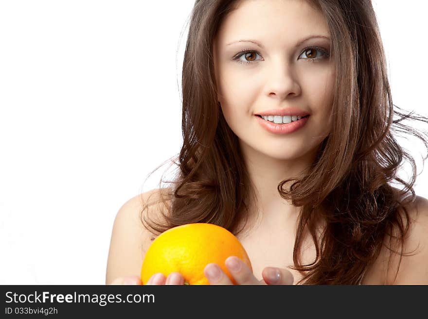 Beautiful young woman holding an orange. Close up. Beautiful young woman holding an orange. Close up