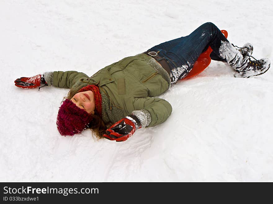 Girl has fun lying in the snow