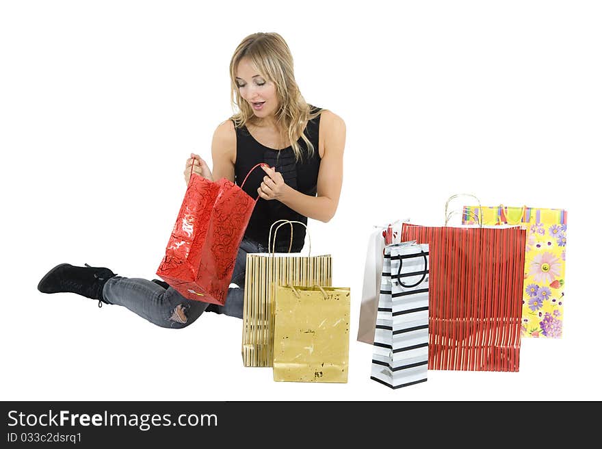 blond woman with shopping bags smiling happily. blond woman with shopping bags smiling happily