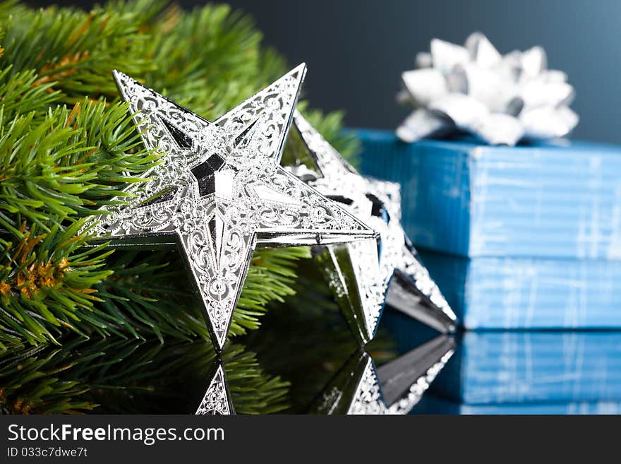 Branch of Christmas tree with gift box and star