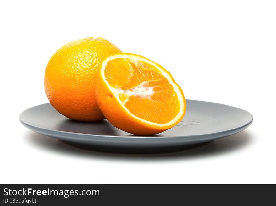 Orange on plate isolate on a white background. Orange on plate isolate on a white background