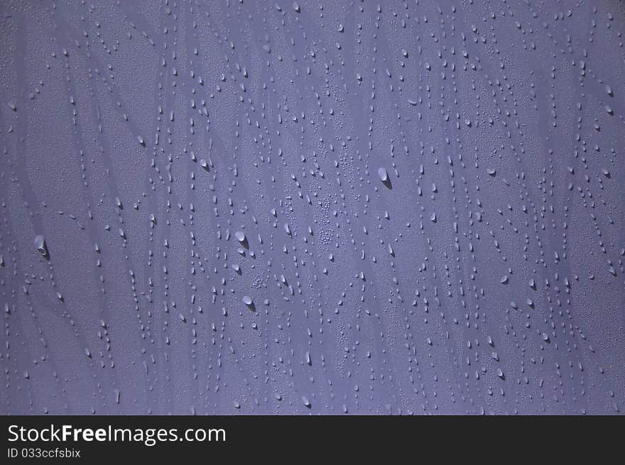 Water drop on the purple wall. Water drop on the purple wall