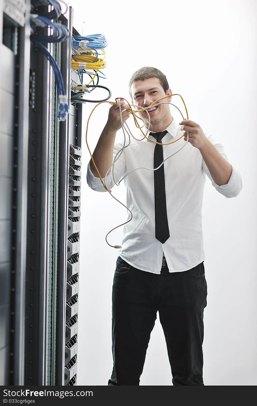 Young handsome business man  engeneer in datacenter server room. Young handsome business man  engeneer in datacenter server room