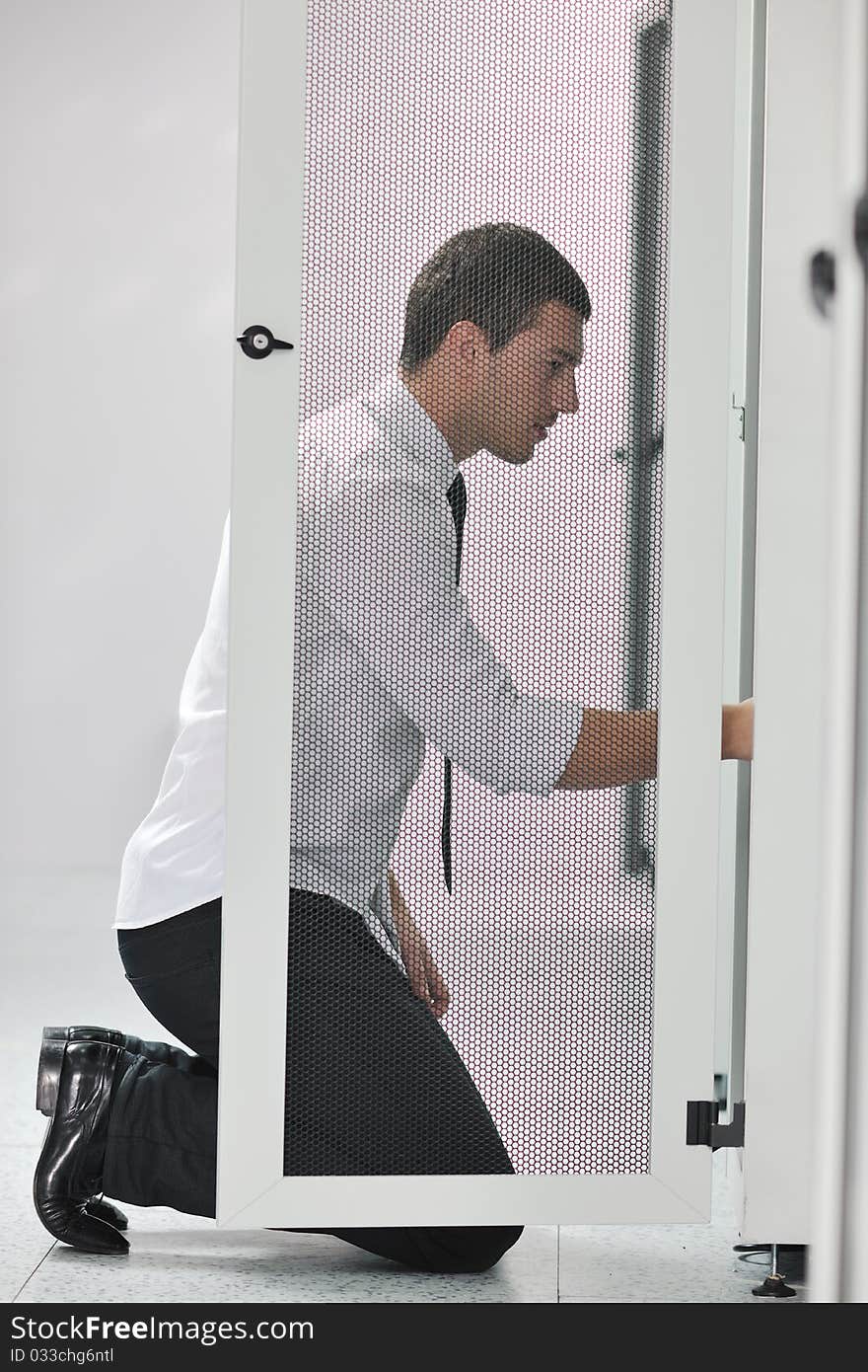 Young handsome business man  engeneer in datacenter server room. Young handsome business man  engeneer in datacenter server room