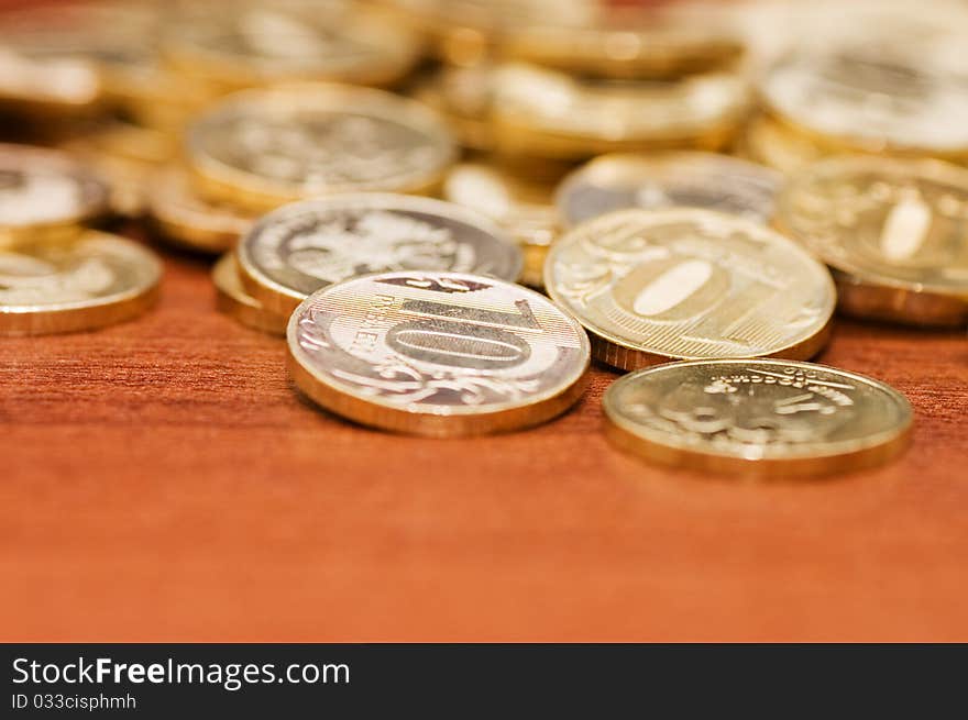 Golden Coins On A Wooden Table