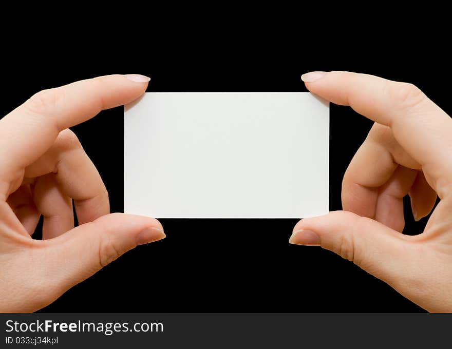 Paper card in woman hand isolated on black background