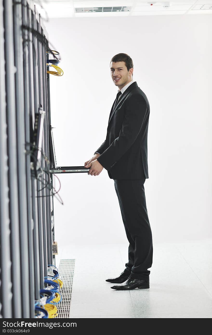 Young engeneer in datacenter server room