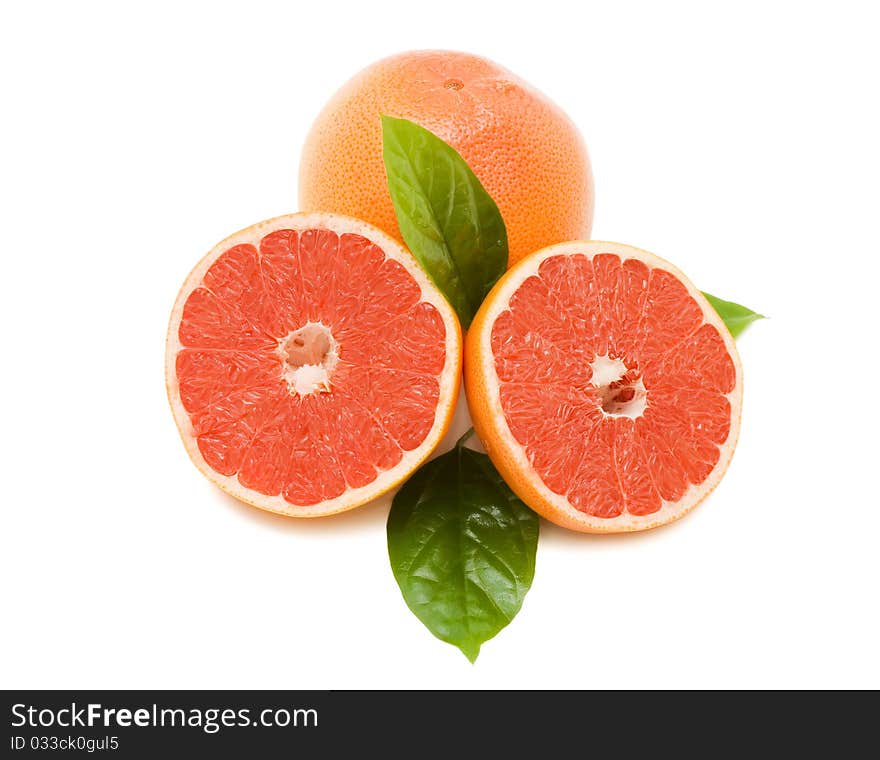 Fresh juicy grapefruits with green leafs. Isolated