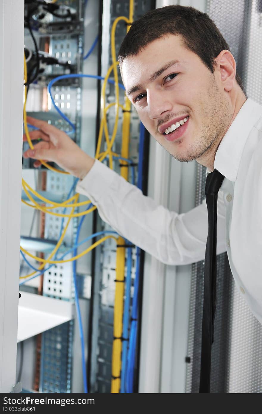 Young handsome business man  engeneer in datacenter server room. Young handsome business man  engeneer in datacenter server room