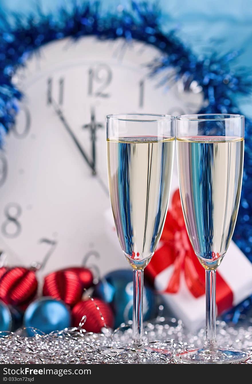 Two glasses with wine against a big clock