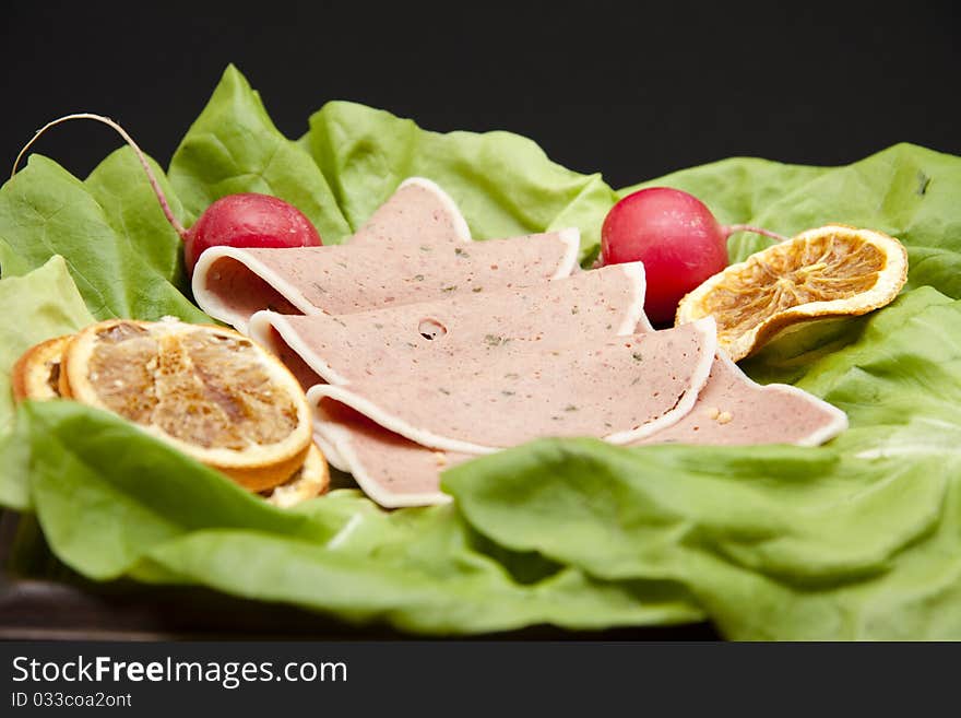 Liver pastry with lemon onto lettuce leaves