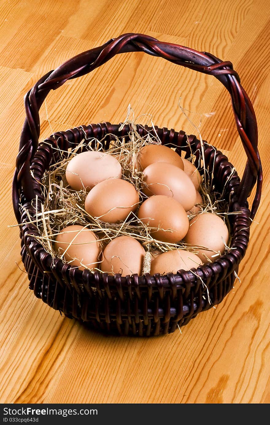 Fresh farm eggs in the basket with hay. Fresh farm eggs in the basket with hay