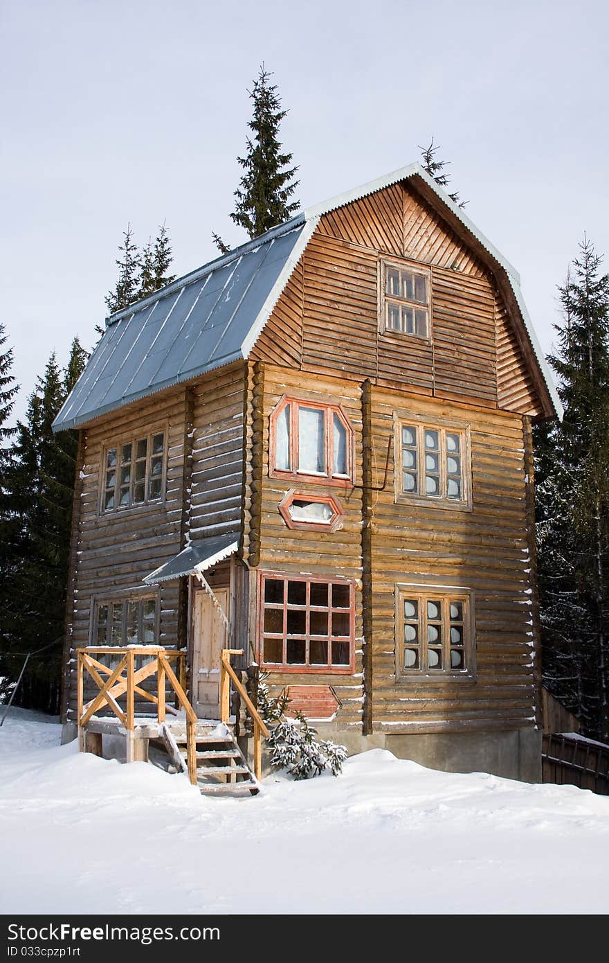 Three-storeyed wooden house concealed by snow